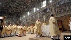 Vatican -- This handout picture released by the Press office shows Pope Francis (c), Argentina's Jorge Mario Bergoglio, leading a mass at the Sistine Chapel a day after his election, 14Mar2013