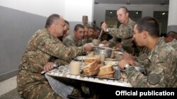 Armenia - Defense Minister Seyran Ohanian (L) dines with soldiers at a military base in Tavush province, 20Aug2013.