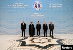 (Left to right) Azerbaijani President Ilham Aliyev, Iranian President Ebrahim Raisi, Turkmen President Serdar Berdymukhammedov, Russian President Vladimir Putin, and Kazakh President Qasym-Zhomart Toqaev pose for a picture at the Caspian summit in Ashgabat on June 29.