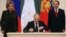Президент России Владимир Путин подписывает договор, по которому Крым стал частью России. Рядом председатель Совета Федерации Валентина Матвиенко и спикер Госдумы, лидер "Единой России" Сергей Нарышкин (справа). Москва, 21 марта 2014 года.