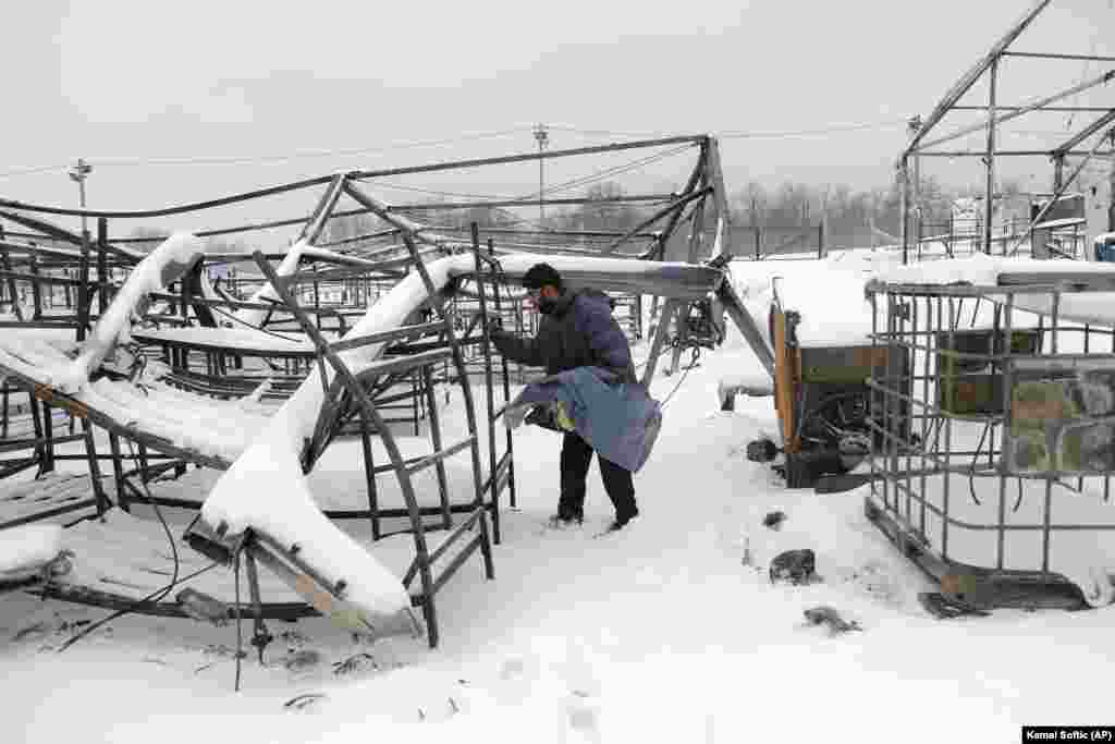 A migrant looks for belongings at the camp after the fire. Lipa was a temporary reception center, but when local authorities in September 2020 closed another camp, Bira in Bihac, which could sleep around 3,000 people, about 300 people from Bira were sent to Lipa, which was already overcrowded. Bira was closed, according to local authorities, because the it posed a security and health risk.