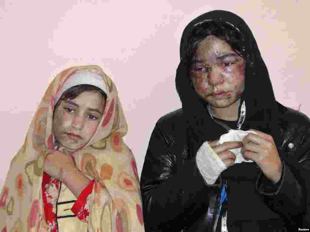 Young girls at a Konduz hospital for treatment for themselves and other family members after an acid attack by an unknown gunman on their home on November 30. (REUTERS/ Whadat)