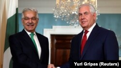 FILE: U.S. Secretary of State Rex Tillerson (R) shakes hands with Pakistan's Foreign Minister Khawaja Muhammad Asif in Washington on October 4