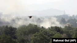 Smoke rises after a rocket attack in the city of Kabul, during Independence Day celebrations in Kabul on August 18.