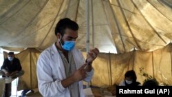 A doctor fills a syringe with the Johnson & Johnson COVID-19 vaccine at a vaccination center in Kabul on July 11, 2021. The COVID-19 vaccines were donated by the United States and delivered through the UN.