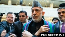 Former Afghan President Hamid Karzai (center) arrives for "intra-Afghan" peace talks in Moscow on February 5. 