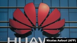 CHINA -- The Huawei logo stands on a Huawei office building in Dongguan in China’s southern Guangdong province, December 18, 2018