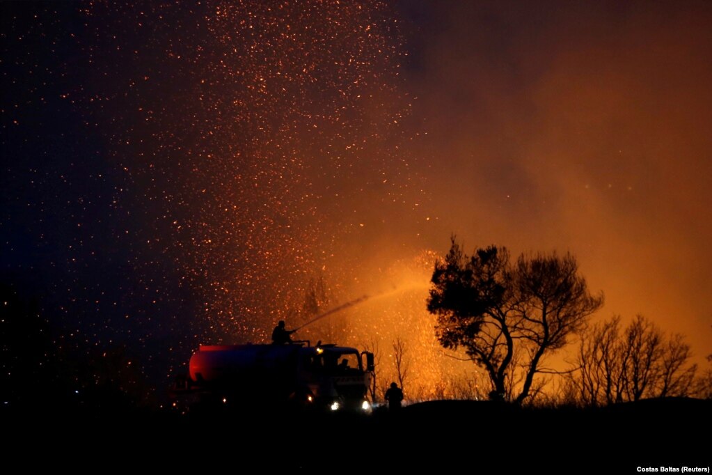 Zjarrfikësit duke bërë përpjekje për shuarjen e një zjarri të egër në Varimpompi, në veri të Athinës, në Greqi. (3 gusht)