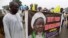 Protesters from the pro-Iranian Islamic Movement in Nigeria (IMN) holds a banner with a photograph of detained leader Ibrahim Zakzaky to press for his release in northern Nigerian city of Kano, on August 11, 2016. 