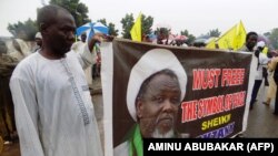 Protesters from the pro-Iranian Islamic Movement in Nigeria (IMN) holds a banner with a photograph of detained leader Ibrahim Zakzaky to press for his release in northern Nigerian city of Kano, on August 11, 2016. 