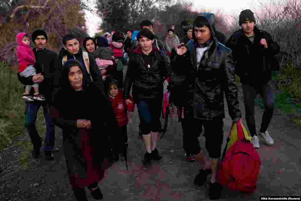 Migrants from Afghanistan walk along the seaside after arriving near the village of Skala Sikamias on the Greek island of Lesbos on March 2. A day earlier, Greek police said at least 1,000 migrants have reached Greece&#39;s Eastern Aegean islands.