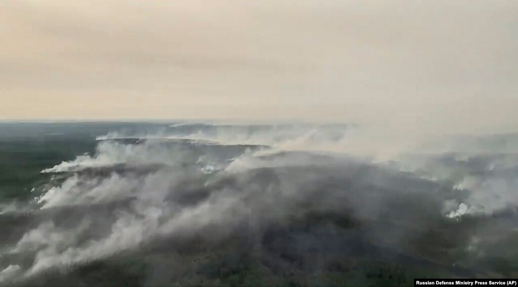 An aerial view of smoke from forest fires on July 17. The Russian military has used heavy-lift transport planes to douse the wildfires in Siberia. Russia's Defense Ministry said that military helicopters also dropped water to extinguish fires and carried firefighters into the area to try and stop them.