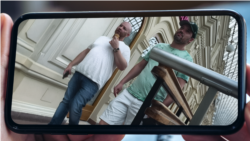 In this image provided to RFE/RL, Kyle Nagy (right) is shown walking in central Moscow in the summer of 2024, some months after he moved to Russia.