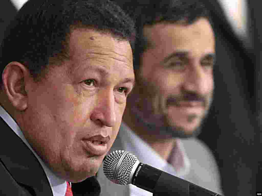 Iran -- President Mahmud Ahmadinejad (R) with his Venezuelan counterpart Hugo Chavez at a press conference in Tehran, 06Sep2009 - Caption: epa01850964 A handout photo provided by Miraflores Press, shows Venezuelan President Hugo Chavez (L) and his Iranian counterpart Mahmoud Ahmadinejad (R) talking to media during the signing of bilateral agreements in Teheran, Iran, 06 September 2009.