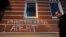 A graffiti message reading "Foreign agent" is spray painted on the wall of the Memorial human rights group's offices in central Moscow.