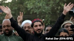 FILE: Leader of Pashtun Protection Movement (PTM) Manzoor Pastheen (C) waves to supporters during a demonstration in Lahore (April 2018)