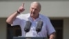 Belarusian President Alyaksandr Lukashenka gestures at a rally of his supporters on Independence Square in Minsk on August 16, where many thousands more later rallied against him. 