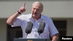 Belarusian President Alyaksandr Lukashenka gestures at a rally of his supporters on Independence Square in Minsk on August 16, where many thousands more later rallied against him. 