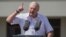 Belarusian President Alyaksandr Lukashenka gestures at a rally of his supporters on Independence Square in Minsk on August 16, where many thousands more later rallied against him. 