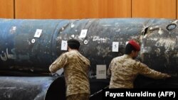 Saudi soldiers reveal the remains of missiles, that a military coalition led by Saudi Arabia claim are Iranian during a press conference at the Armed Forces club in Riyadh, March 26, 2018