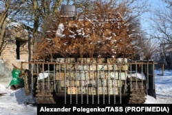An armored vehicle fitted with hedgehog armor and chains designed to snag FPV drones is pictured at the Zaporizhzhya workshop.