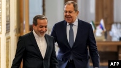 Iranian Foreign Minister Abbas Araghchi (left) and his Russia counterpart, Sergei Lavrov, walk together after meeting in Tehran in February. 