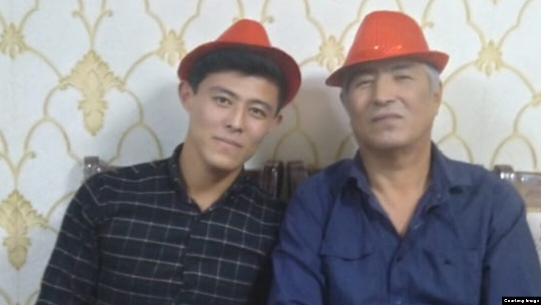 A family photograph of Uzbek opposition activist Khurram Berdiev (right) with his son.