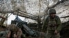 FILE PHOTO: Ukrainian servicemen fire a self-propelled howitzer towards Russian troops near the frontline town of Pokrovsk
