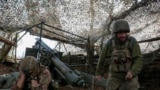 FILE PHOTO: Ukrainian servicemen fire a self-propelled howitzer towards Russian troops near the frontline town of Pokrovsk