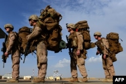 U.S. and British forces withdraw from their base in the southern province of Helmand