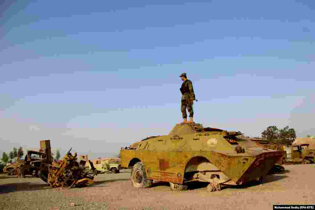 An Afghan soldier stands in a junkyard of Soviet-era tanks on the 29th anniversary of the Soviet-Afghan War, in Kandahar on February 15. (epa-EFE/Muhammad Sadiq)