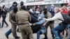 Law enforcement officers drag a demonstrator during a rally in support of detained Belarusian opposition leader Maryya Kalesnikava in Minsk in September 2020. 