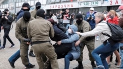 Law enforcement officers drag a demonstrator during a rally in support of detained Belarusian opposition leader Maryya Kalesnikava in Minsk in September 2020. 