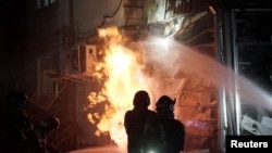 Firefighters extinguish a fire at an apartment building damaged during a Russian drone strike in Kyiv last week.