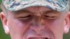 A U.S. Marine eats a scorpion as he participates in a jungle survival program in Thailand.