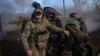 A Ukrainian soldier fires a cannon toward Russian positions at the front line in eastern Ukraine on March 2. 