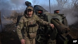 A Ukrainian soldier fires a cannon toward Russian positions at the front line in eastern Ukraine on March 2. 