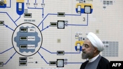 FILE - In this Jan. 13, 2015, file photo released by the Iranian President's Office, President Hassan Rouhani visits the Bushehr nuclear power plant just outside of Bushehr, Iran. Iran announced Tuesday it would inject uranium gas into 1,044 centrifuges i