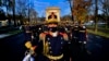 ROMANIA -- Soldiers of to the Romanian Presidential Honor Guard wearing protection masks march in front of the Triumph Arch during a small ceremony organized to mark Romania's Great Union Day, in Bucharest, December 1, 2020