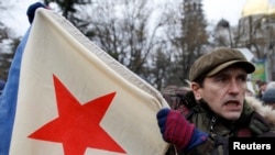 A man hold a Soviet-era military flag during a pro-Russian rally in Simferopol, Crimea, on February 28.