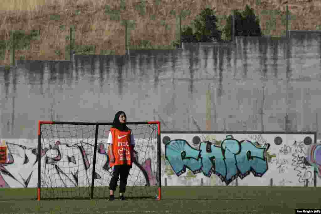 A member of the Afghan girls&#39; national soccer team stands by a goal during a training session at a soccer pitch in Odivelas on the outskirts of Lisbon on September 30.