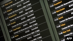 An electronic board shows flight cancellations at Heathrow Airport's Terminal 5 in London on April 15.