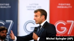 French President Emmanuel Macron delivers a speech to business leaders on the eve of the G7 summit.