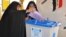 An Iraqi woman casts her ballot in Karbala on April 20.