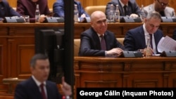 Președintele social-democraților, Sorin Grindeanu, la tribuna Parlamentului. În fundal, premierul Ilie Bolojan.