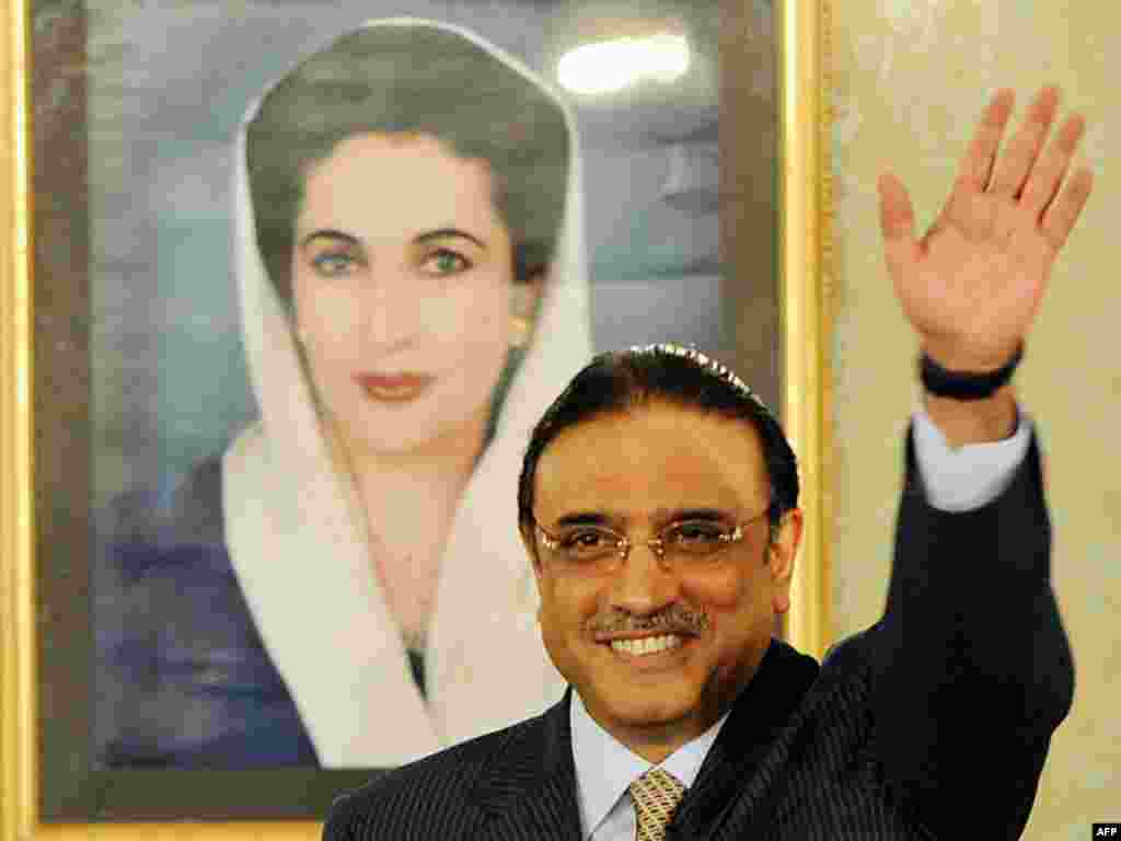 Asif Ali Zardari elected Pakistani president. - President Asif Ali Zardari stands in front of a portrait of his slain wife, Benazir Bhutto, at the Presidential Palace in Islamabad on the day of his inauguration, 09 September 2008 