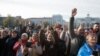 Local residents react during a visit of Ukraine's President Volodymyr in central Kherson