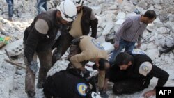 Syrian volunteers search for victims amid the rubble of buildings destroyed by air strikes in Syria's Idlib Province this week.