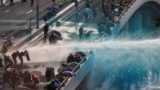 Hong Kong -- Anti-government protesters are sprayed with water cannon by the riot police during a demonstration near Central Government Complex in Hong Kong, China, September 15, 2019