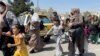 AFGHANISTAN -- Women with their children try to get inside Hamid Karzai International Airport in Kabul, Afghanistan August 16, 2021.